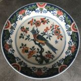 Wall plate in earthenware decorated with painting of flowers and bird 28 cm