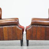 Set of 2 sheep leather wingback chairs with red corduroy seat cushions