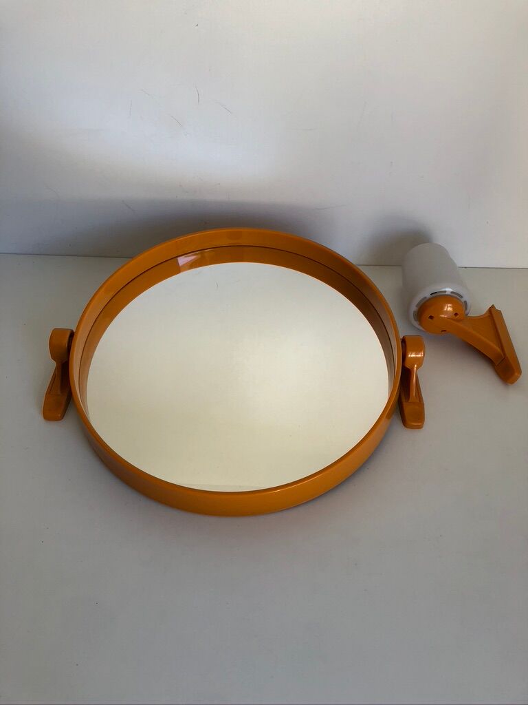 Tiltable orange plastic mirror with matching wall light
