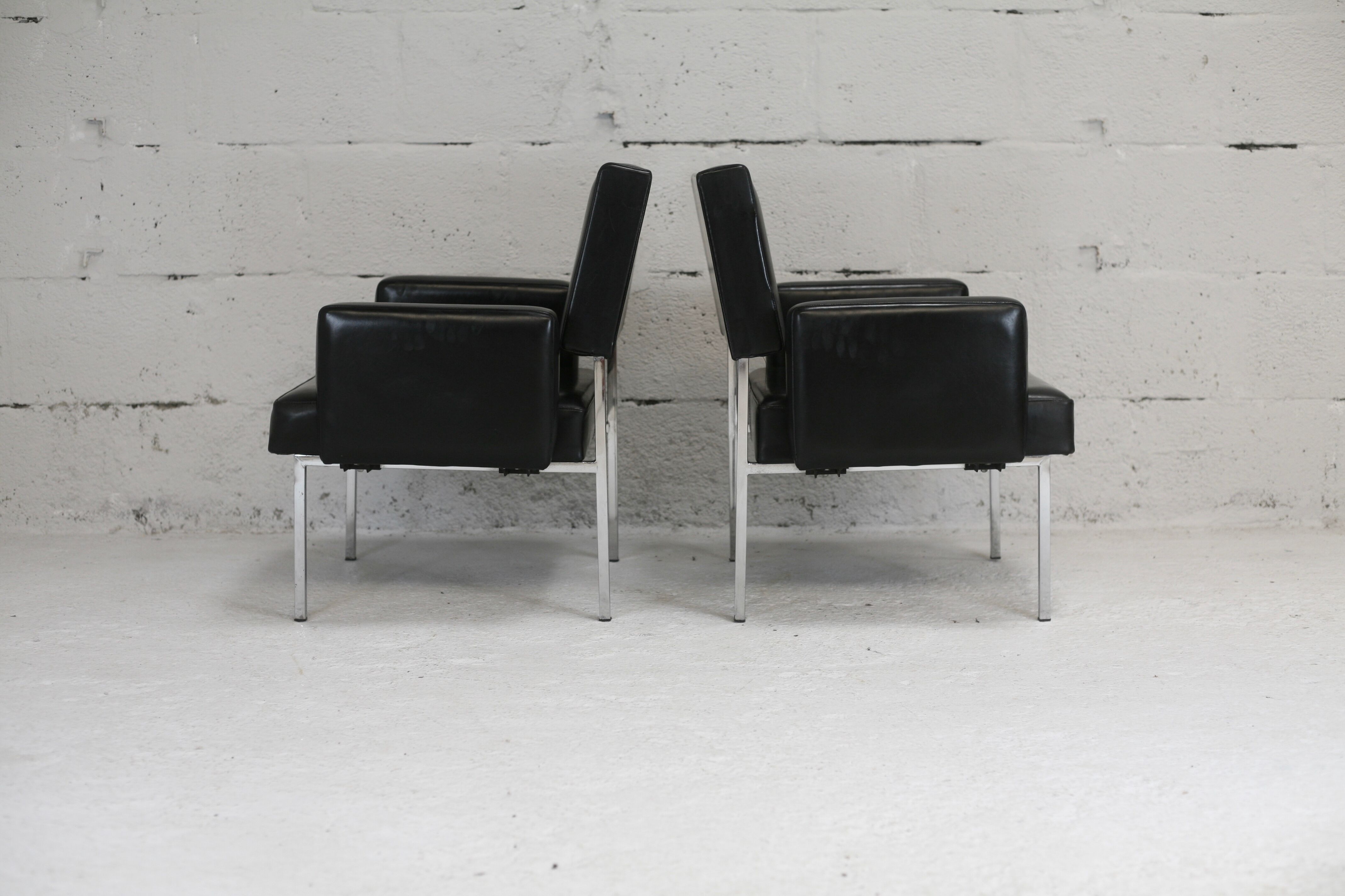 Pair of stainless steel, black leather-like armchairs, France, circa 1970