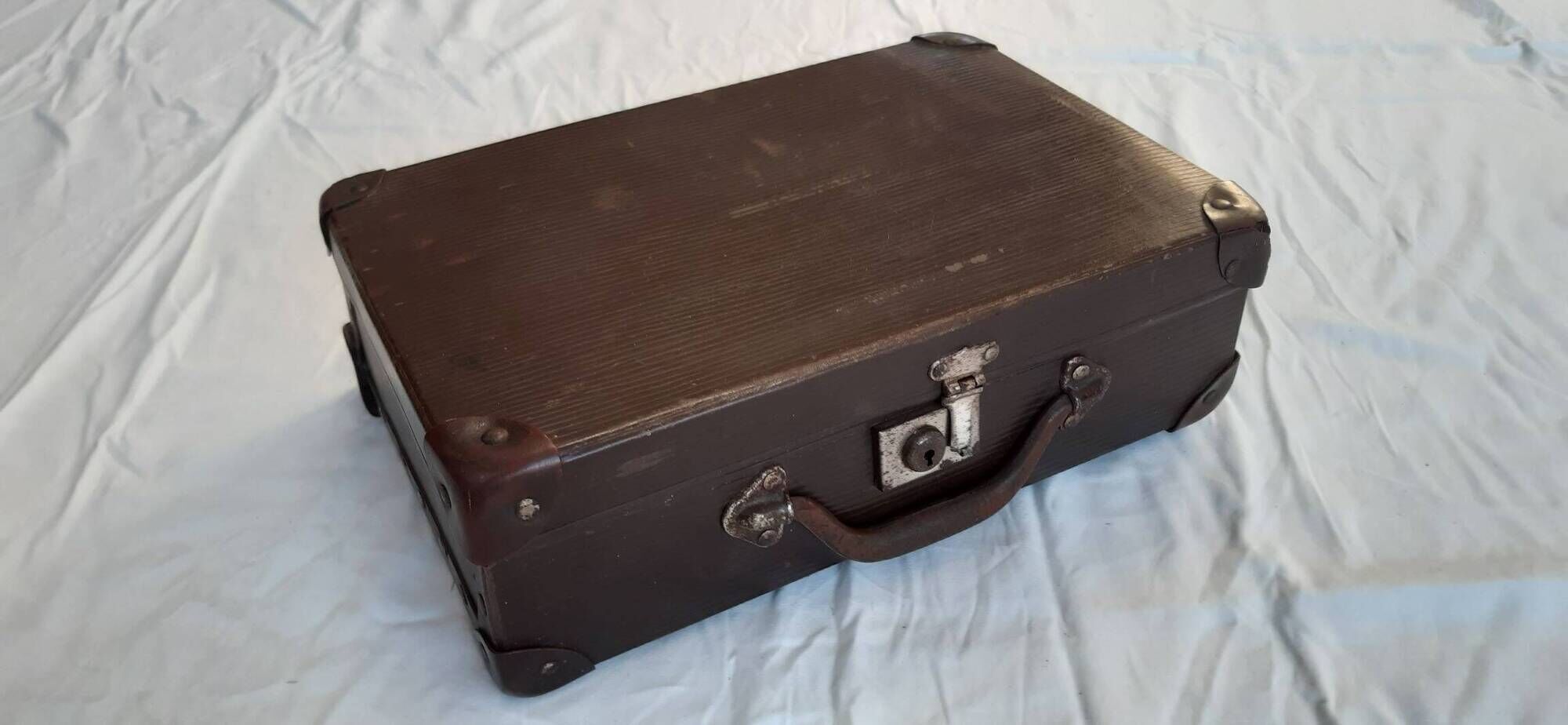 Small old suitcase with a ribbed appearance