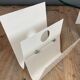White lacquered metal magazine rack from the 1970s
