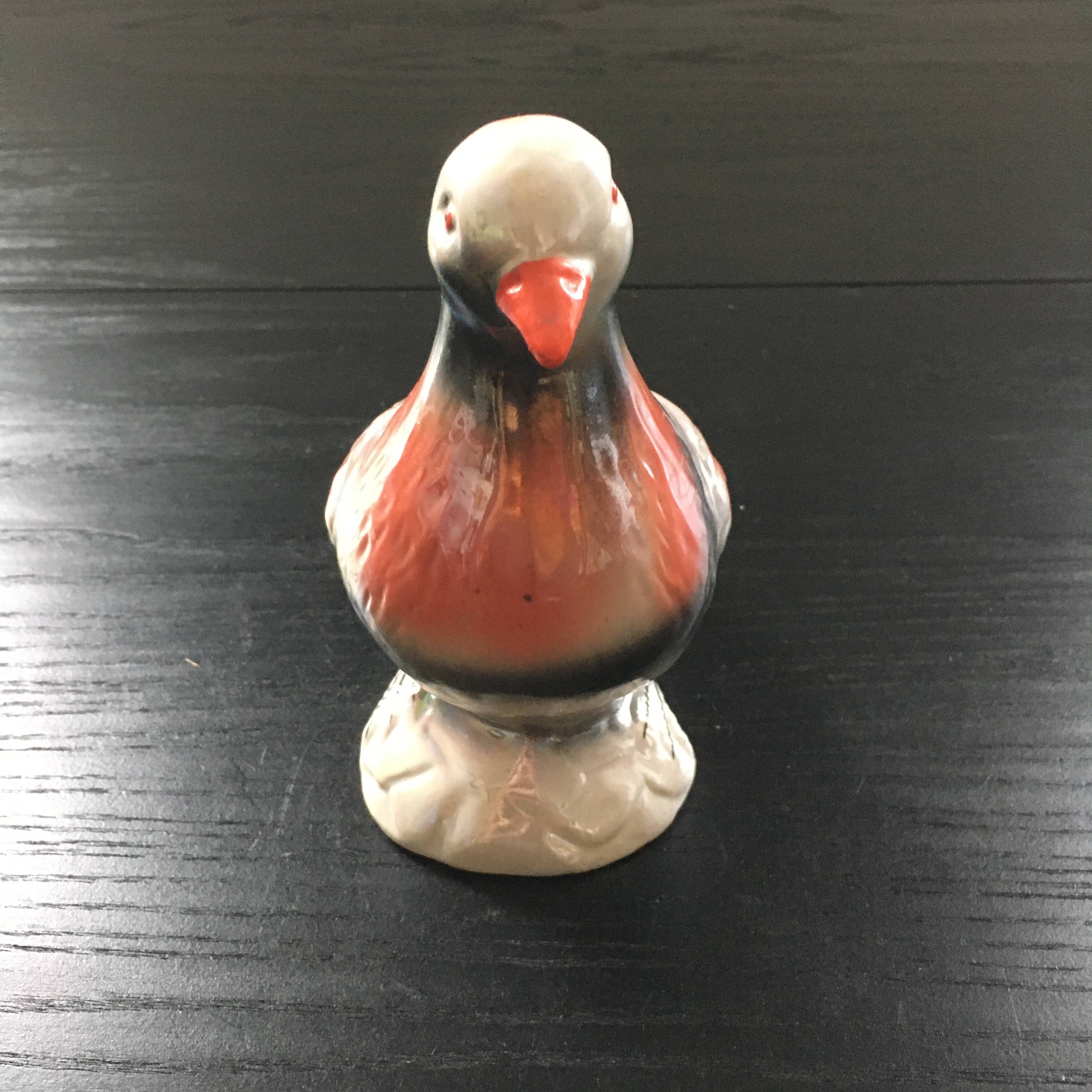 Antique bird in pearly ceramic