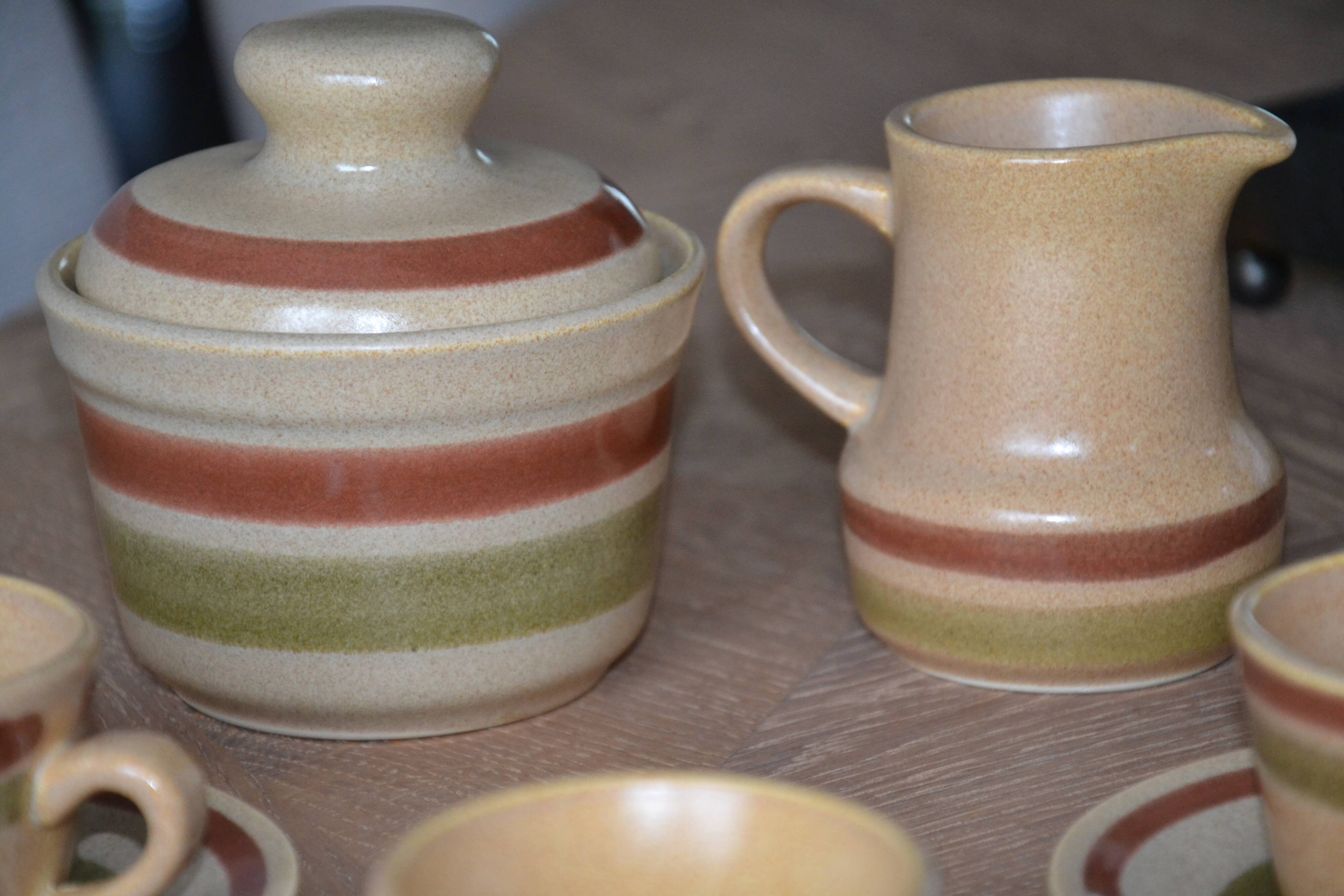 11 St Amand glazed stoneware cups and saucers/sugar bowl/milk jug