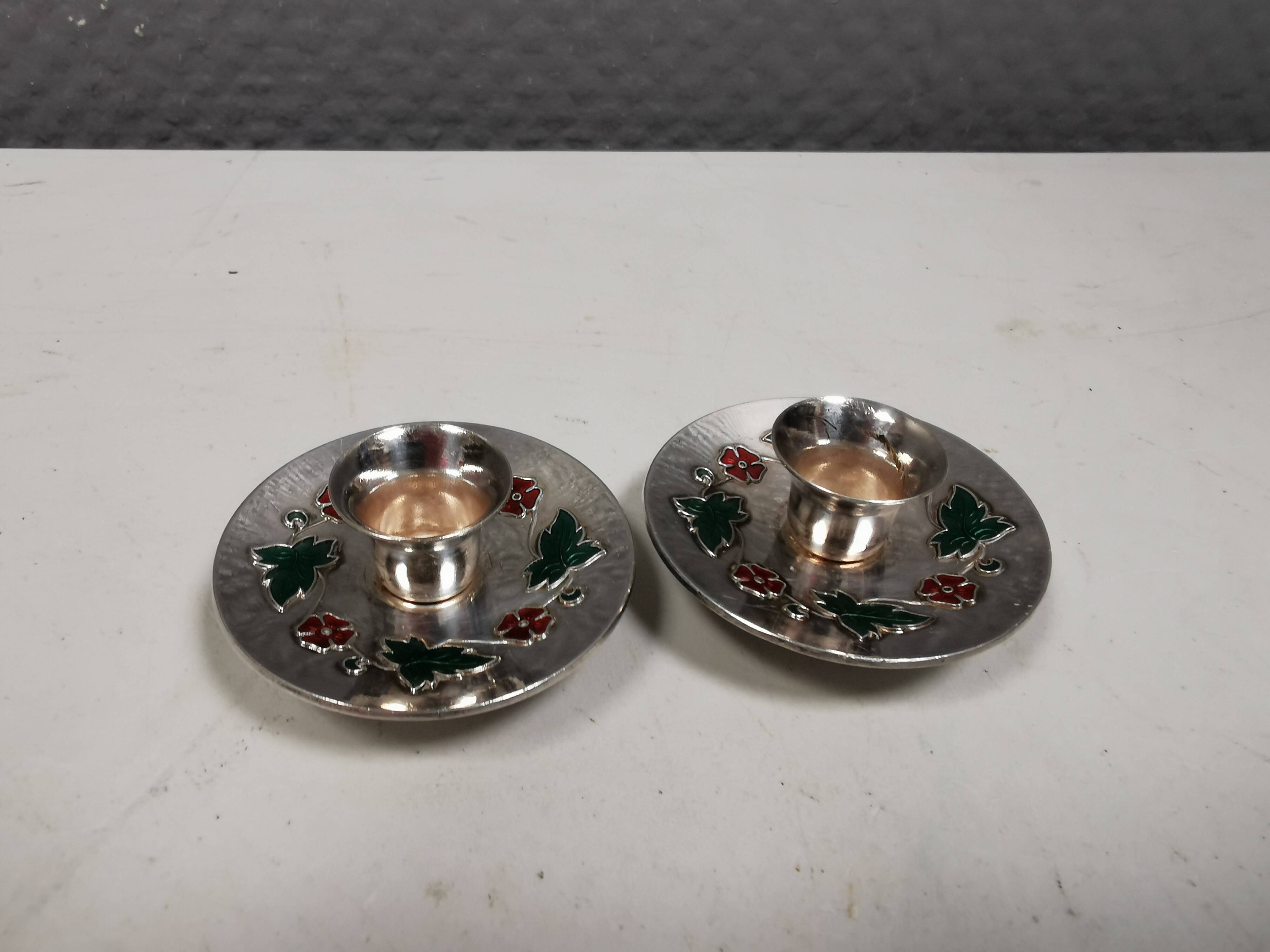 Silver-plated candle holders with inlaid red and green enamel