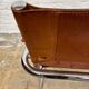 Vintage aluminum tube and tan leather armchair