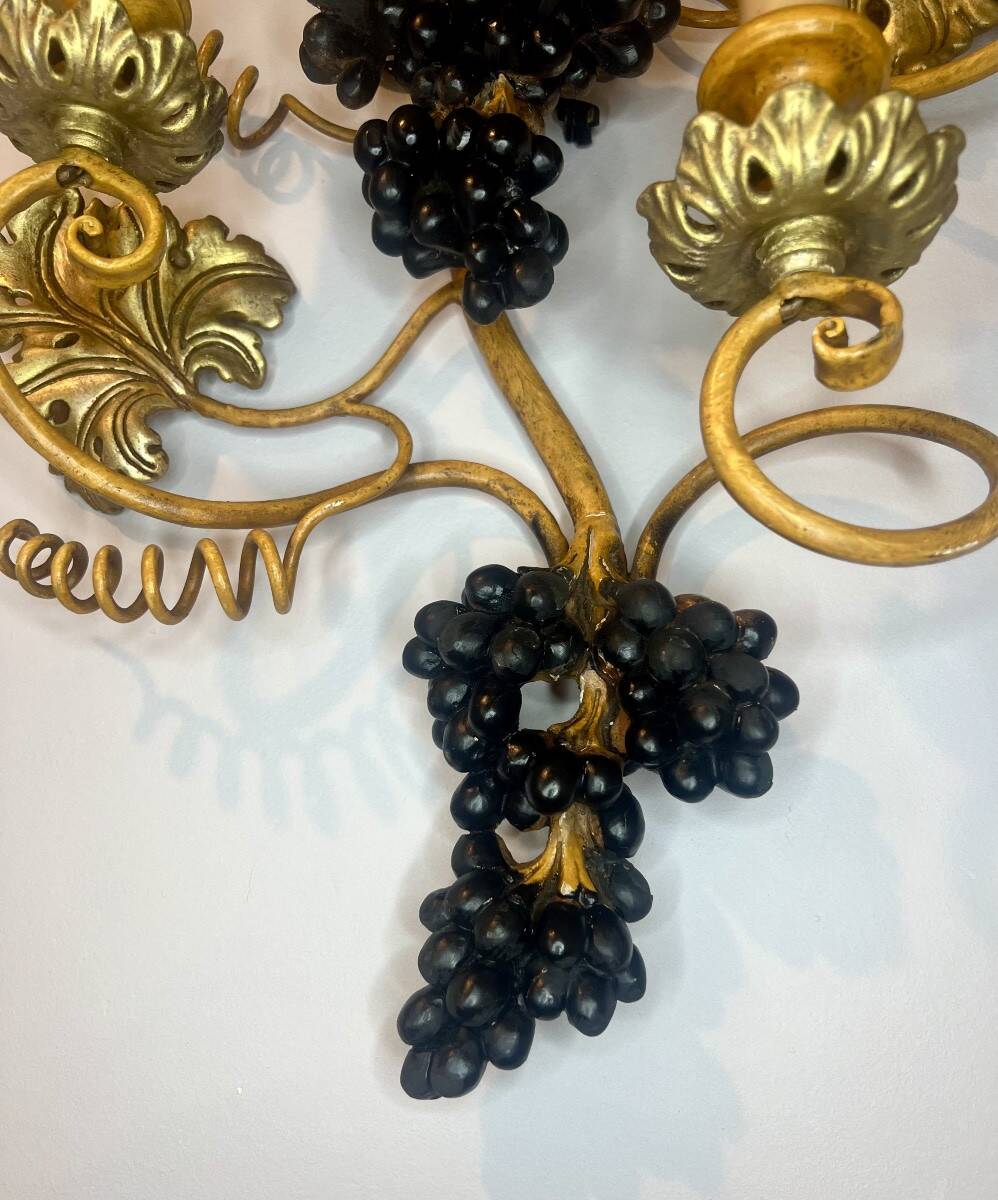 Large pair of wall sconces with vine decorations.