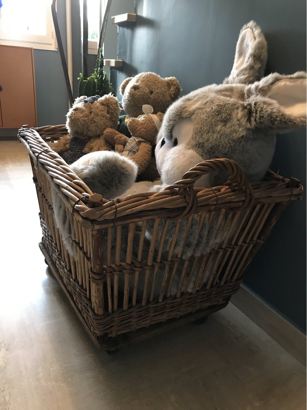 Rattan laundry basket on vintage wheels