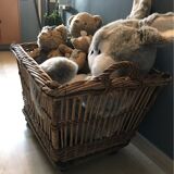 Rattan laundry basket on vintage wheels