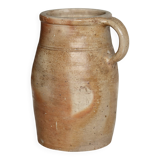 Old rustic stoneware jar with handle