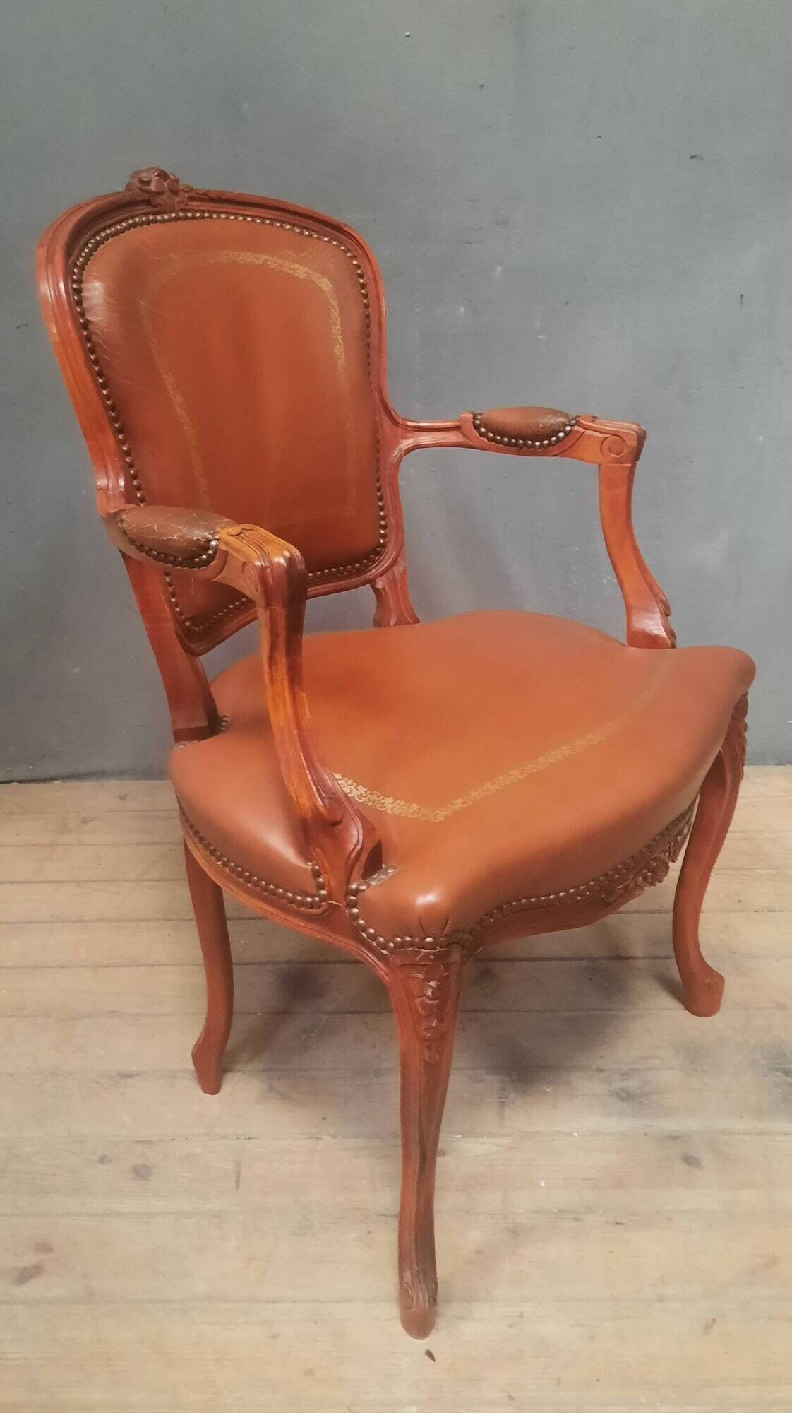 Louis XV style armchair covered in leather.