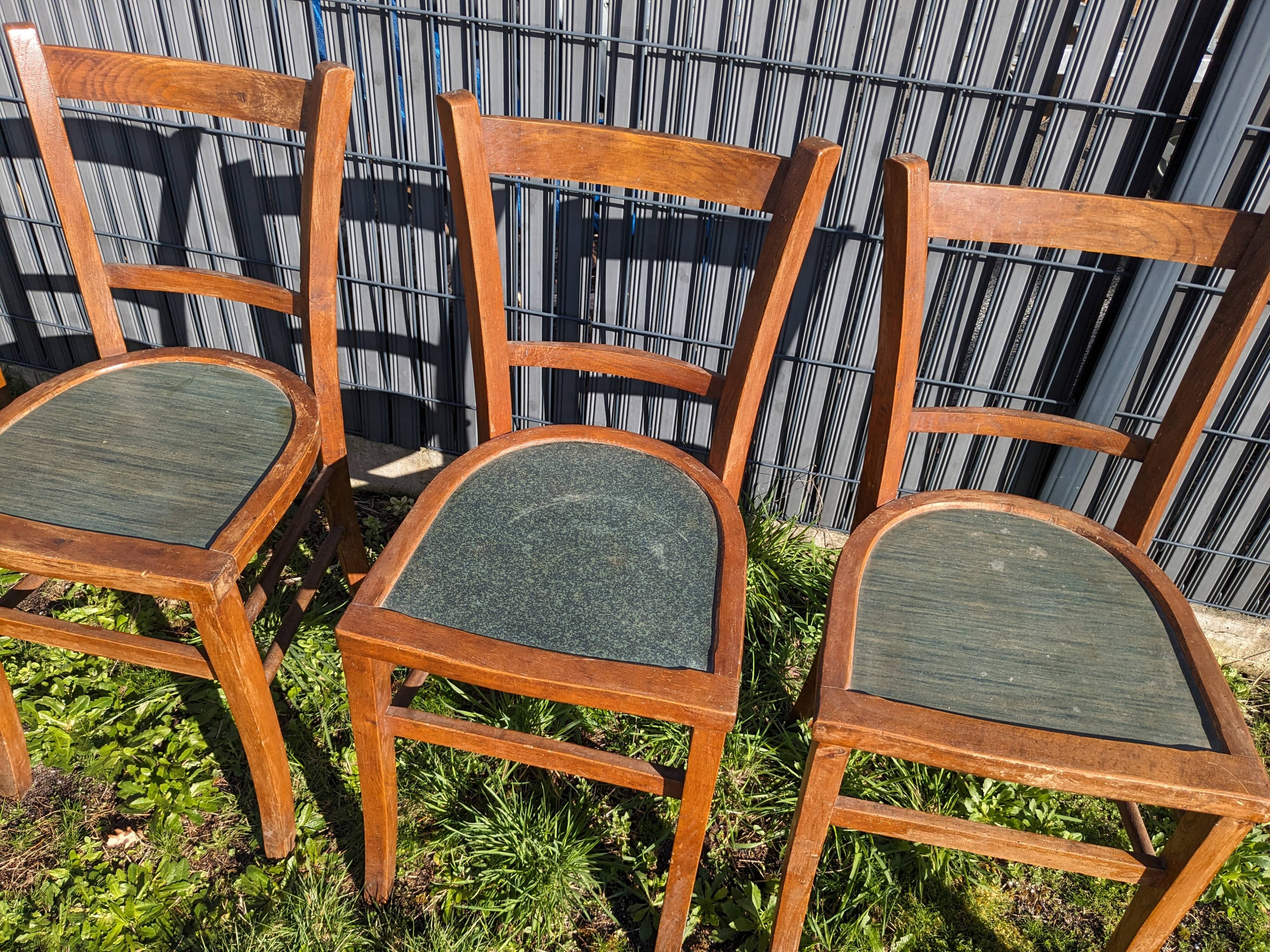 Set of four wooden bistro chairs, green seat, mid-20th century.