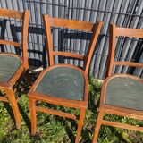 Set of four wooden bistro chairs, green seat, mid-20th century.