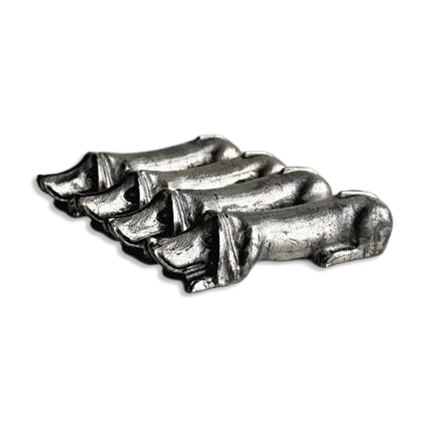 Antique metal knife rest in the shape of a dog.