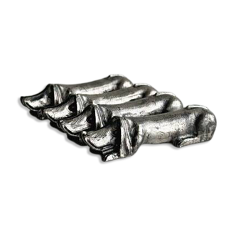 Antique metal knife rest in the shape of a dog.