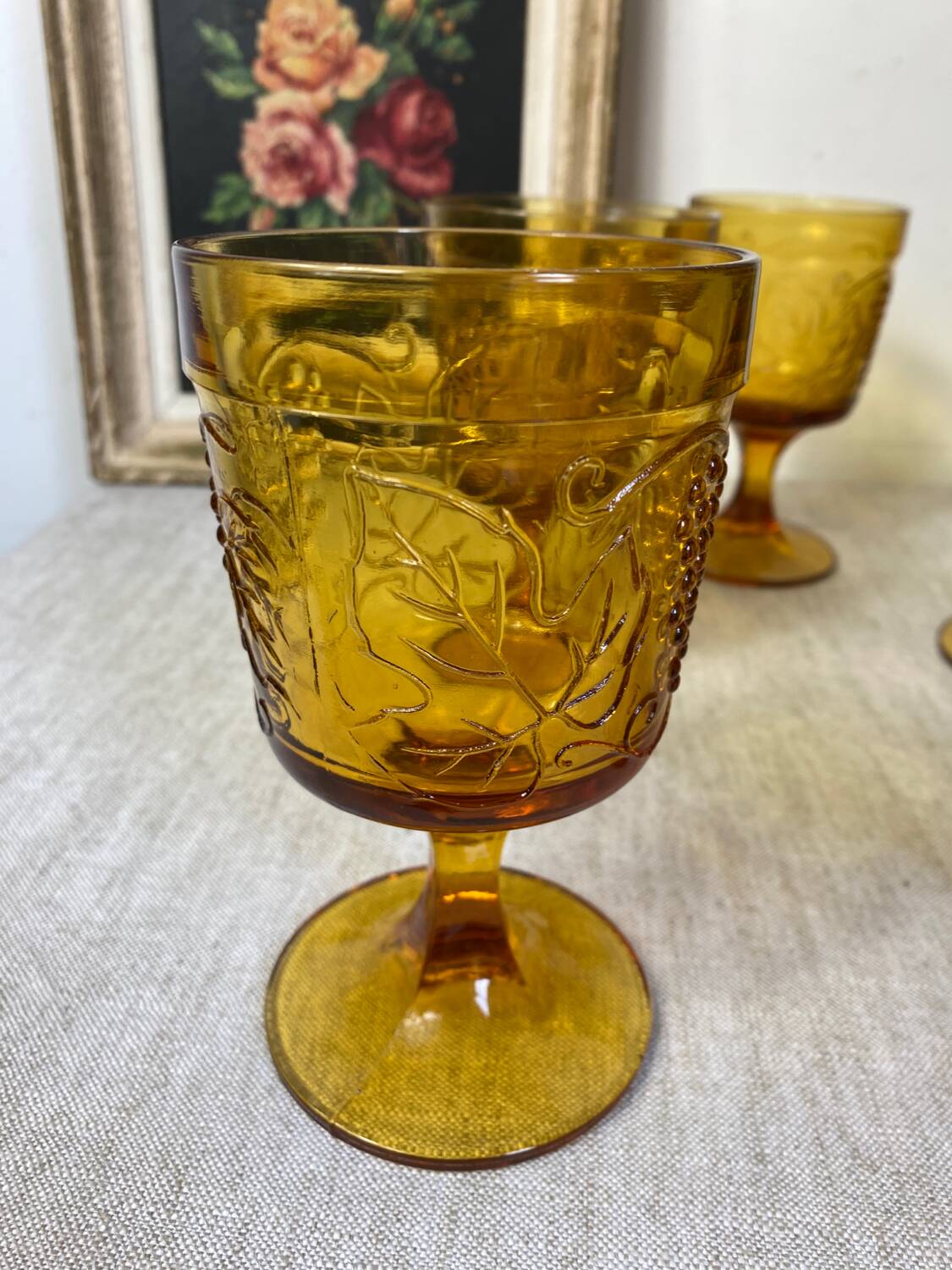 Six amber-colored stemmed glasses
