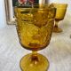 Six amber-colored stemmed glasses