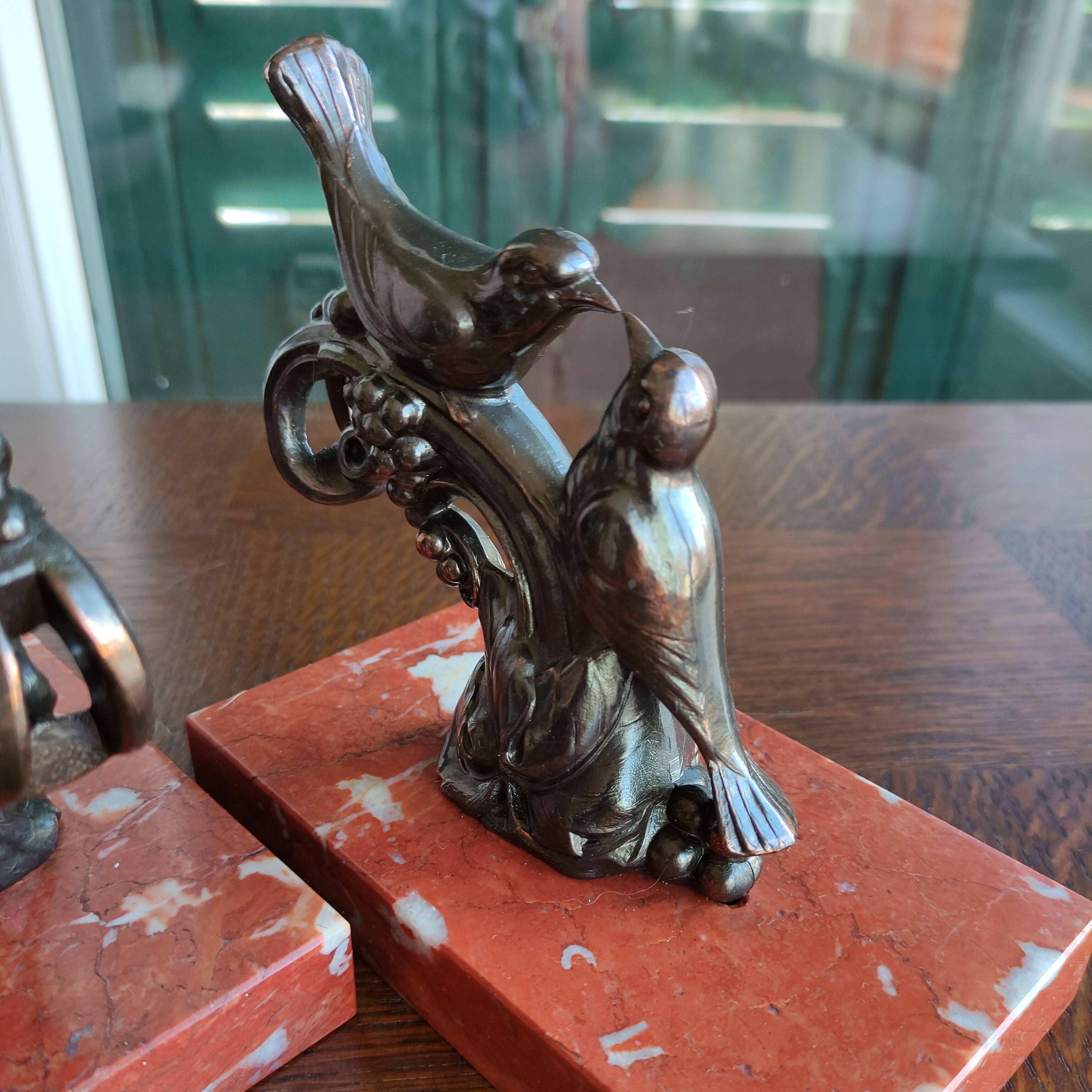 Zinc art bookends in the shape of birds on red marble - warblers