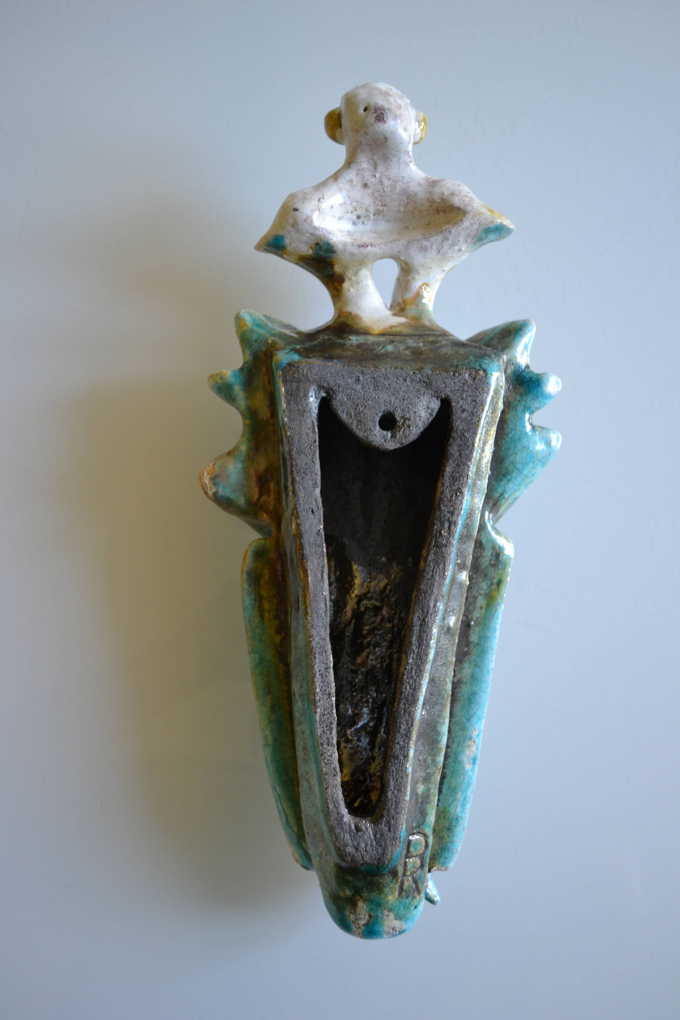 Surreal ceramic sculpture in relief signed to be identified.