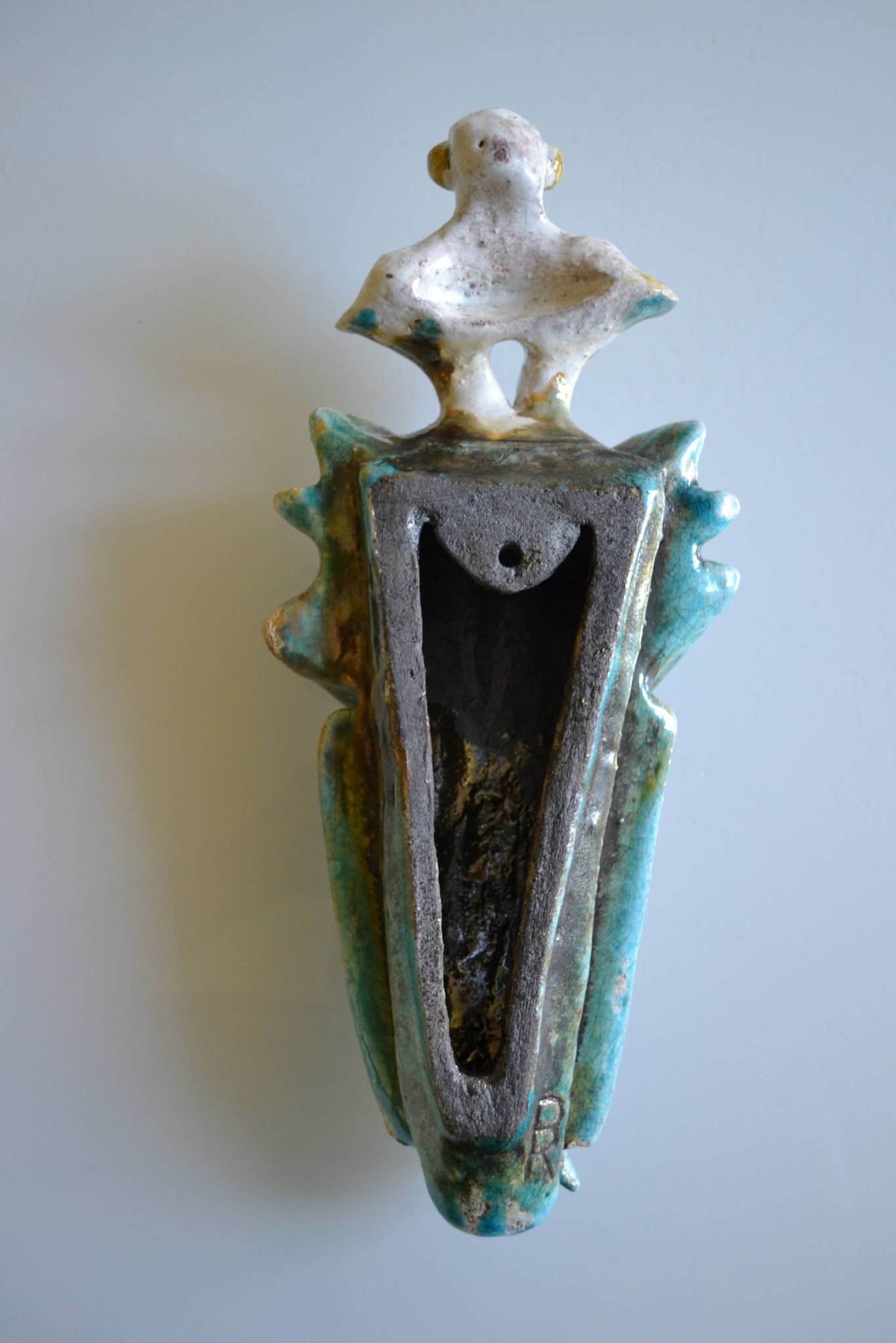Surreal ceramic sculpture in relief signed to be identified.