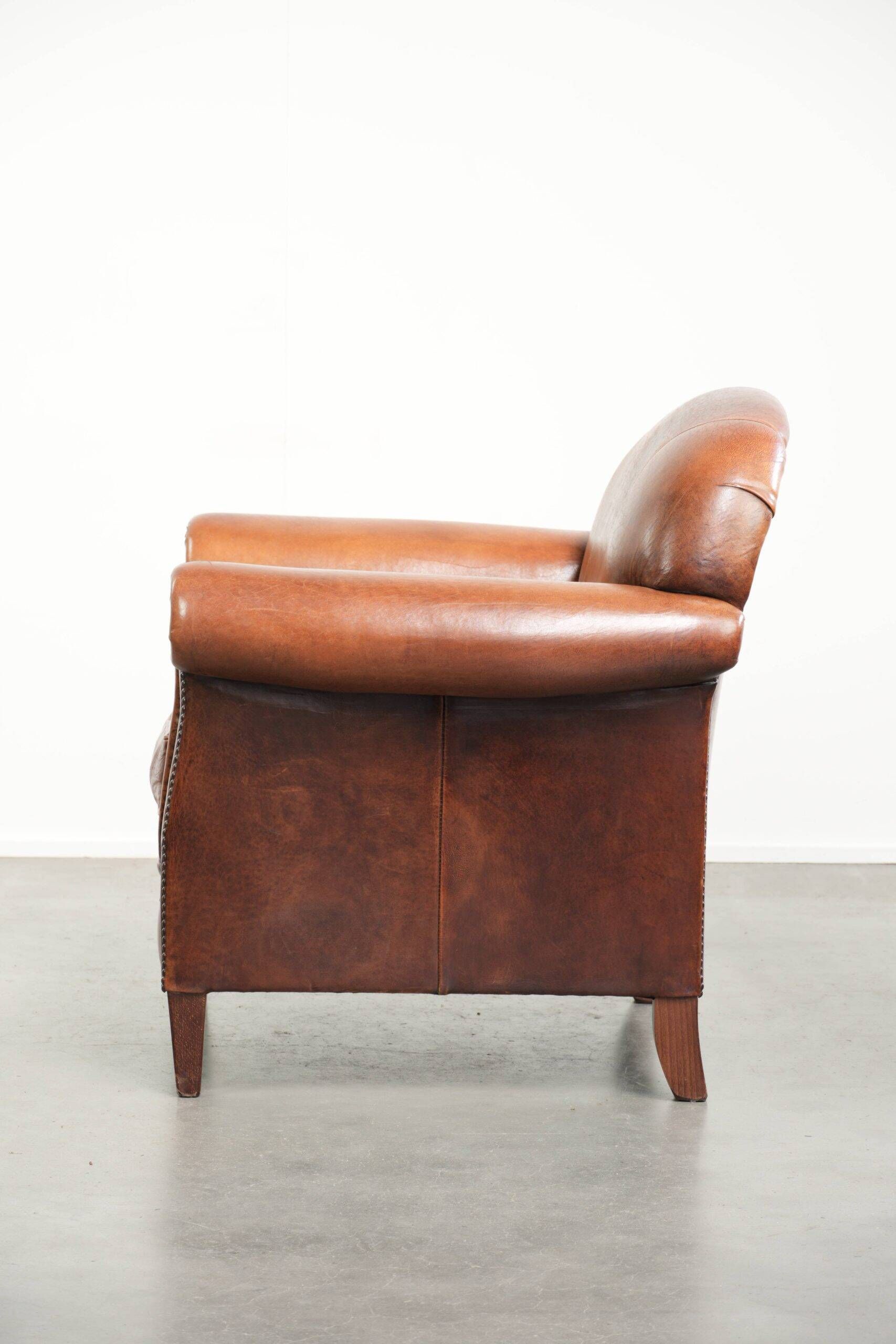 Comfortable vintage sheepskin armchair finished with decorative nails
