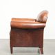 Comfortable vintage sheepskin armchair finished with decorative nails