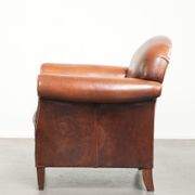 Comfortable vintage sheepskin armchair finished with decorative nails