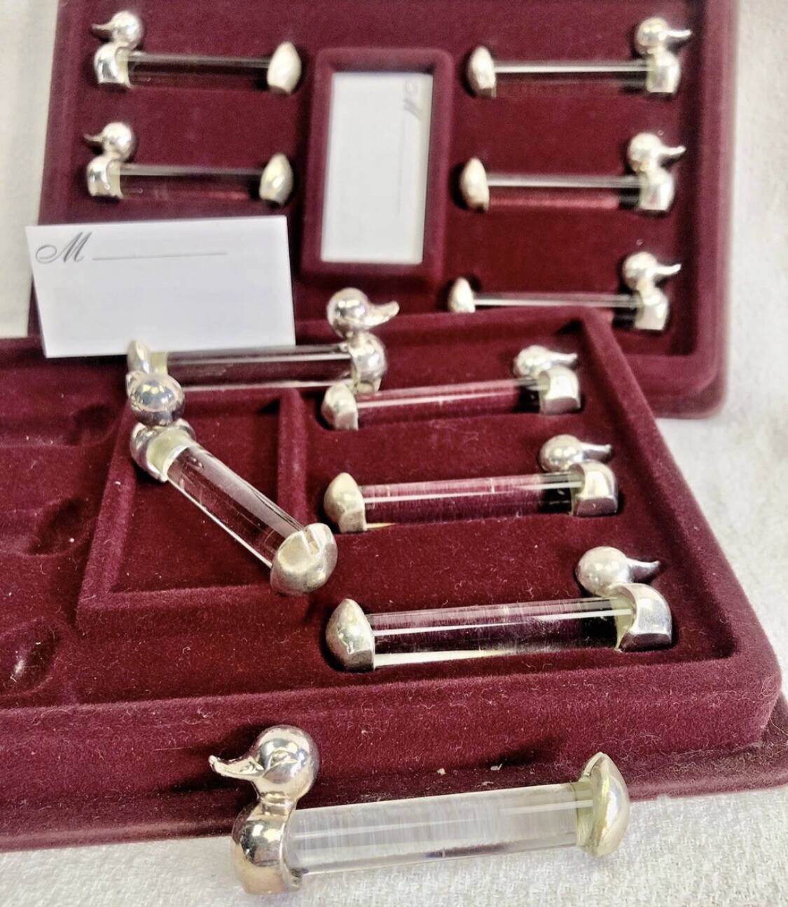 12 silver-plated metal duck knife rests with crystal.