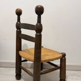 Low fireplace chair in the style of Charles Dudouyt – wood and straw seat.