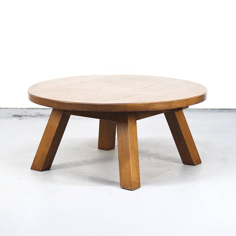 Large rustic vintage coffee table in a round brutalist style.