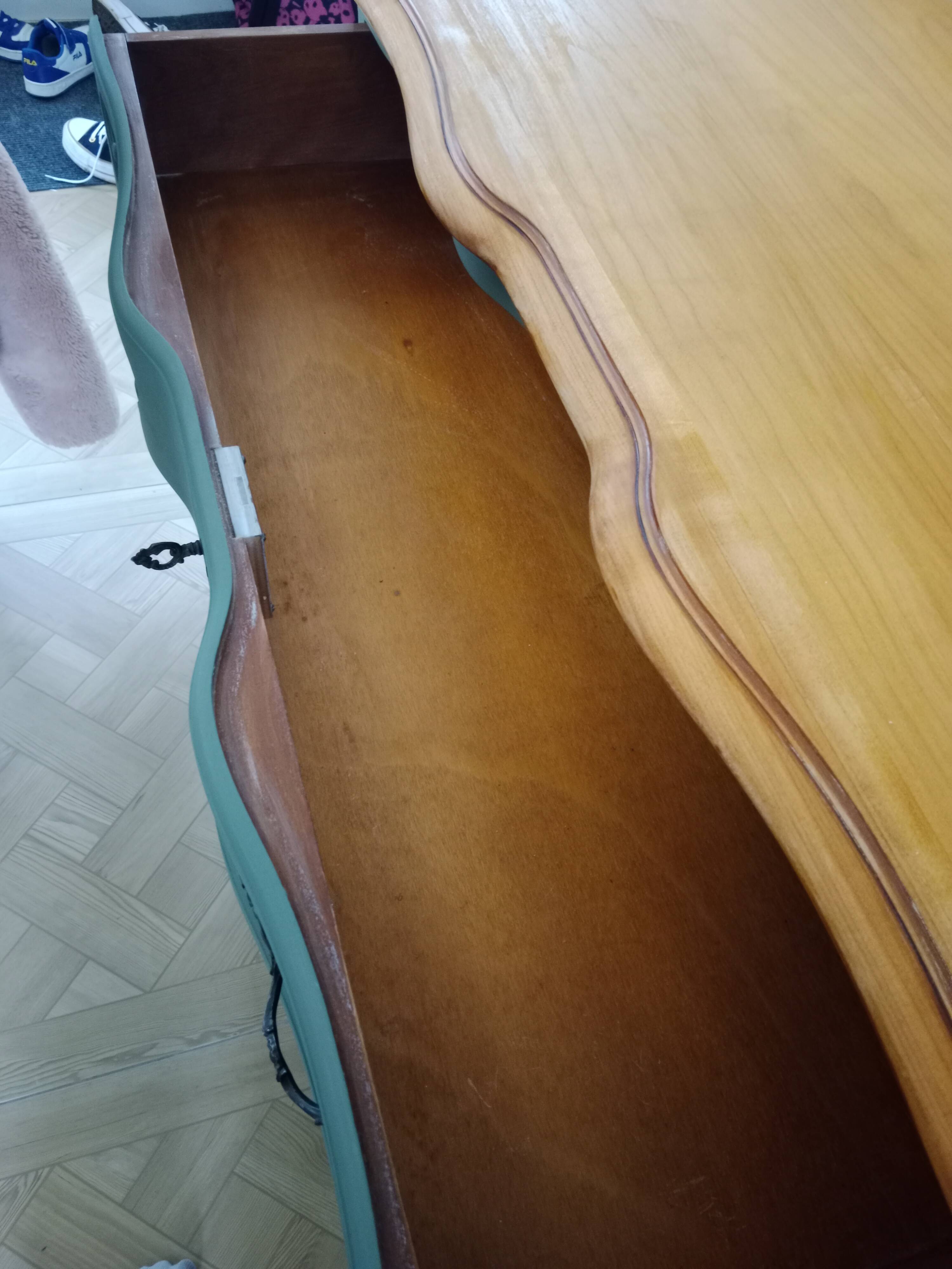 Dark green patina crossbow chest of drawers