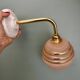 Vintage pink and gold frosted glass globe wall light.