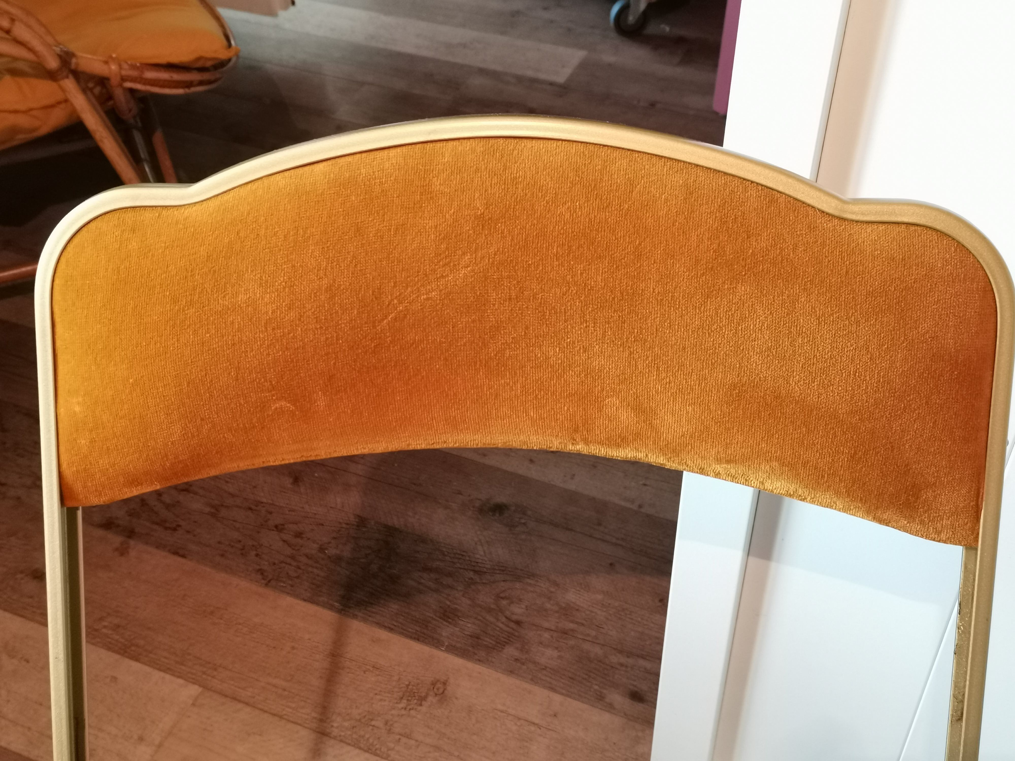 Two gold velvet folding chairs