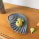Shell-shaped ceramic catchall.