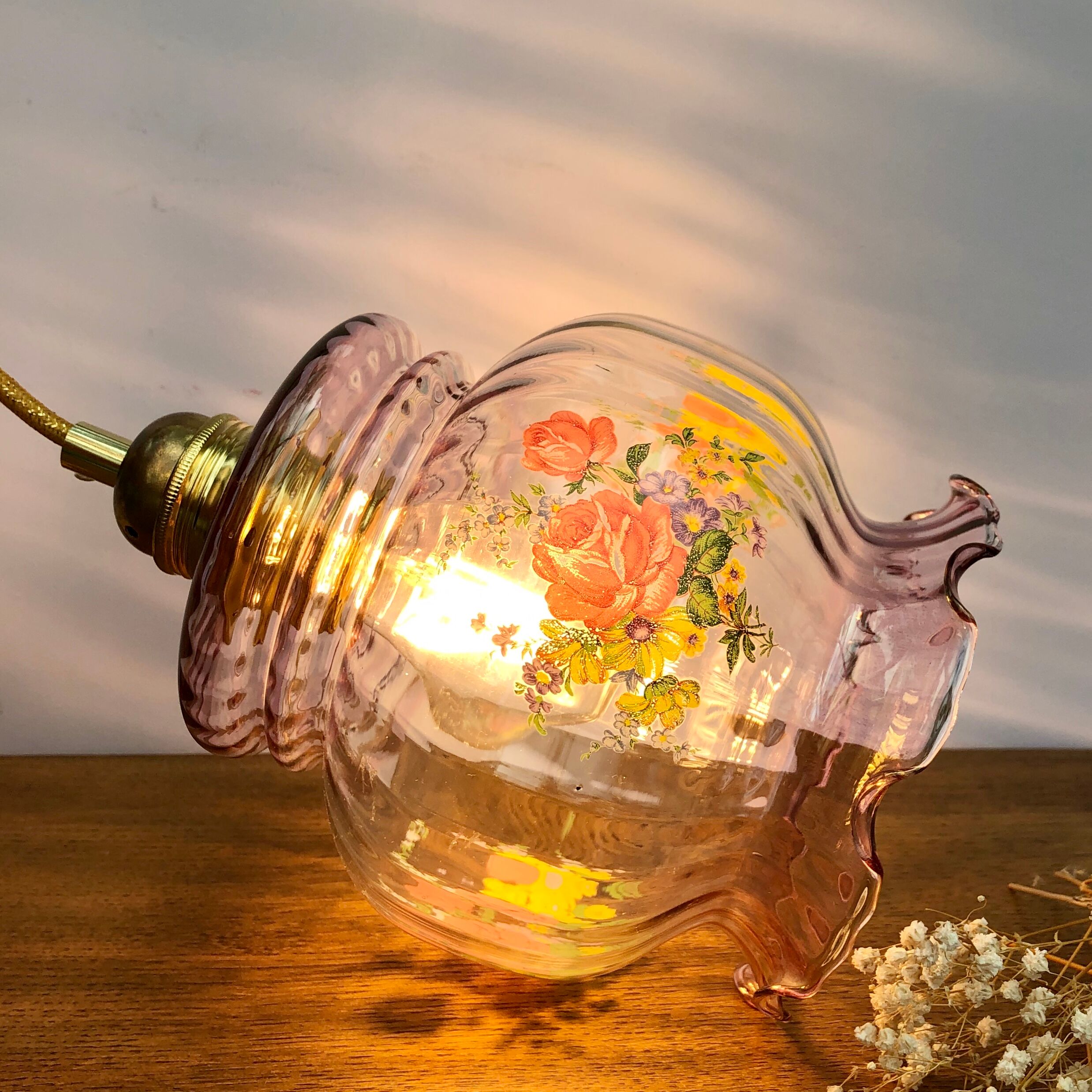 Vintage pink glass hand lamp with flower motifs