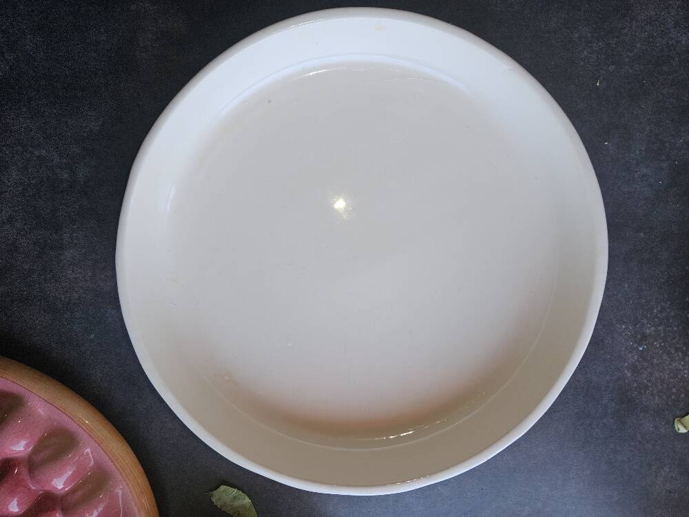 Glazed ceramic dessert plate with strawberry design.