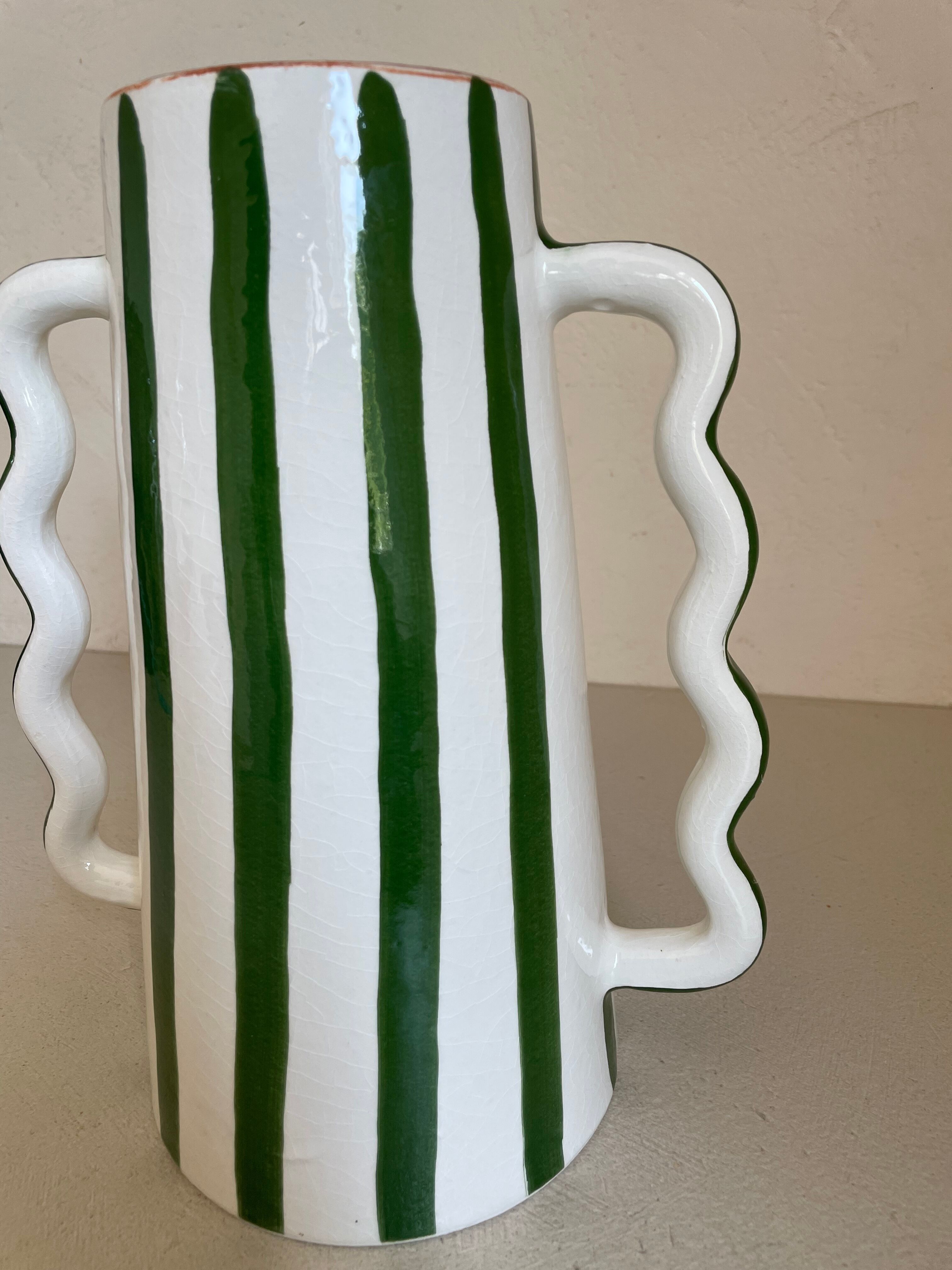 Green and white striped ceramic vase with abstract handmade corrugated handheld