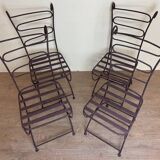 Series of four designer cast iron chairs with reversed backs and very beautiful x-legs