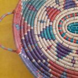 flat basket with 2 handles. Ethnic in multicolored straw.