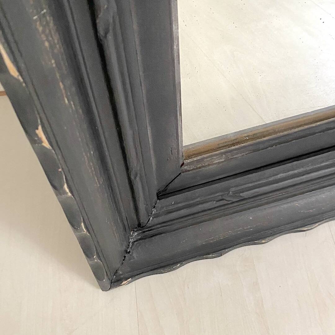 1950s mirror, matte black wood with a patina.