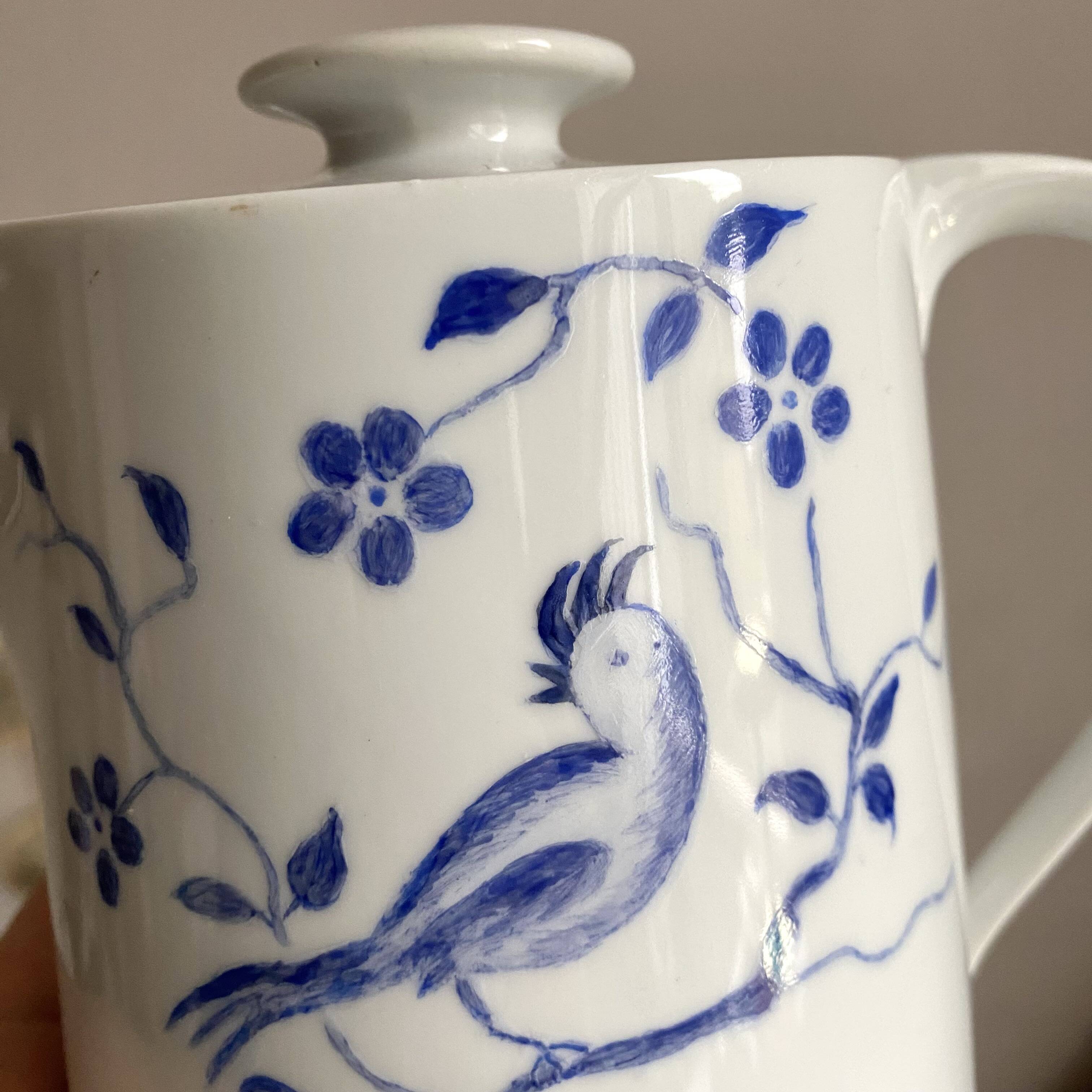 Porcelain teapot with hand-painted bird decoration