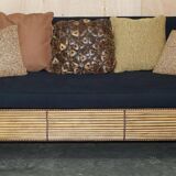 Vintage 1970s canapé with bamboo frame and Aztec patterns.