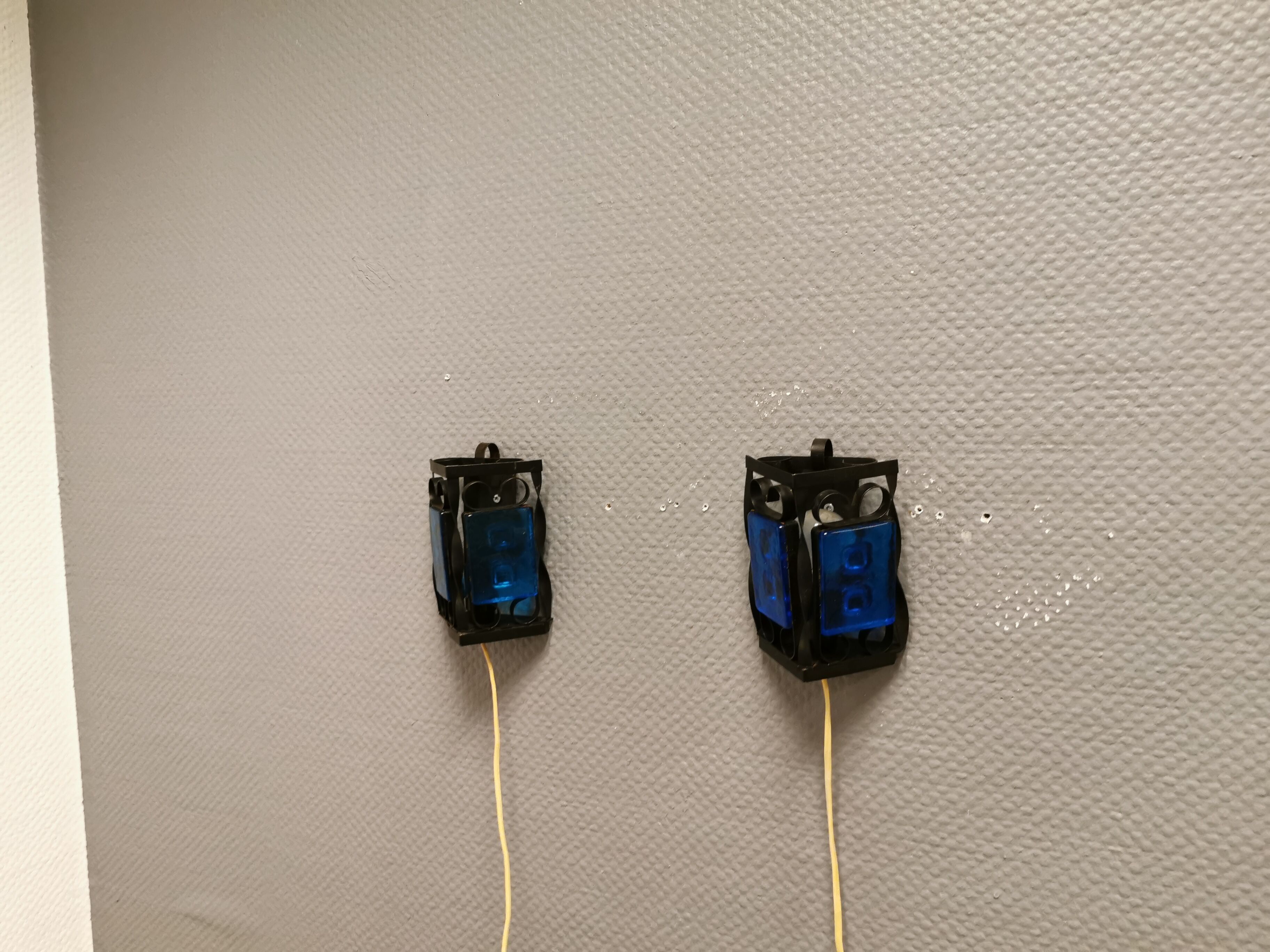 Wall lamps made of black cast iron and handmade thick pressed blue glass