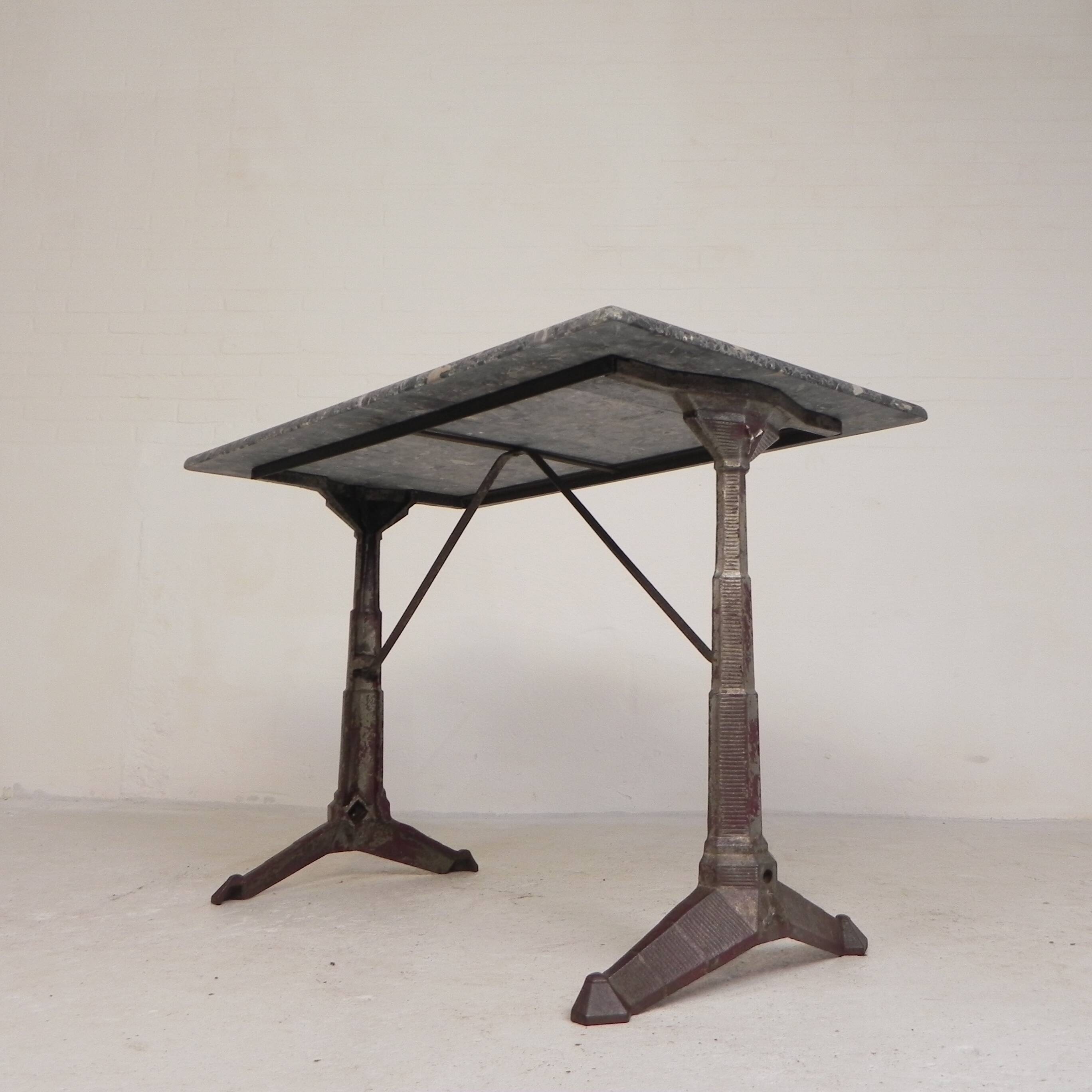 Bistro table with a marble top on a cast iron frame, 1930s.