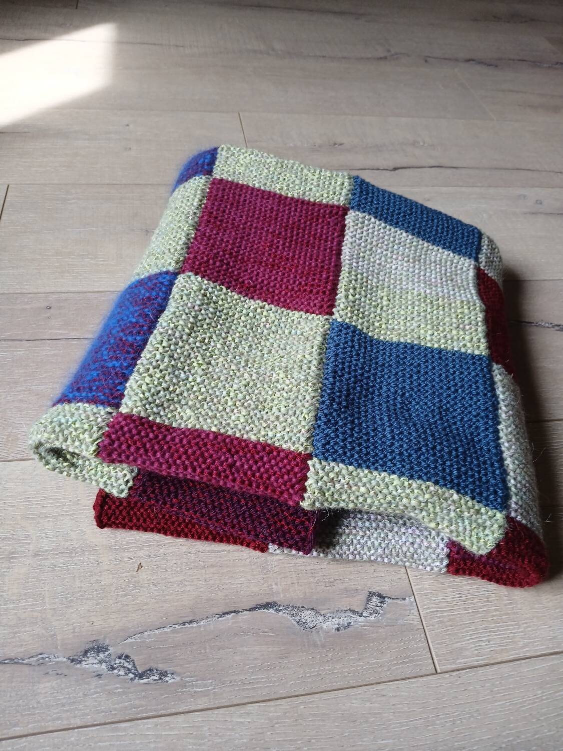 Hand knitted patchwork plaid