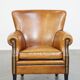 Cognac-colored sheep leather armchair finished with decorative nails