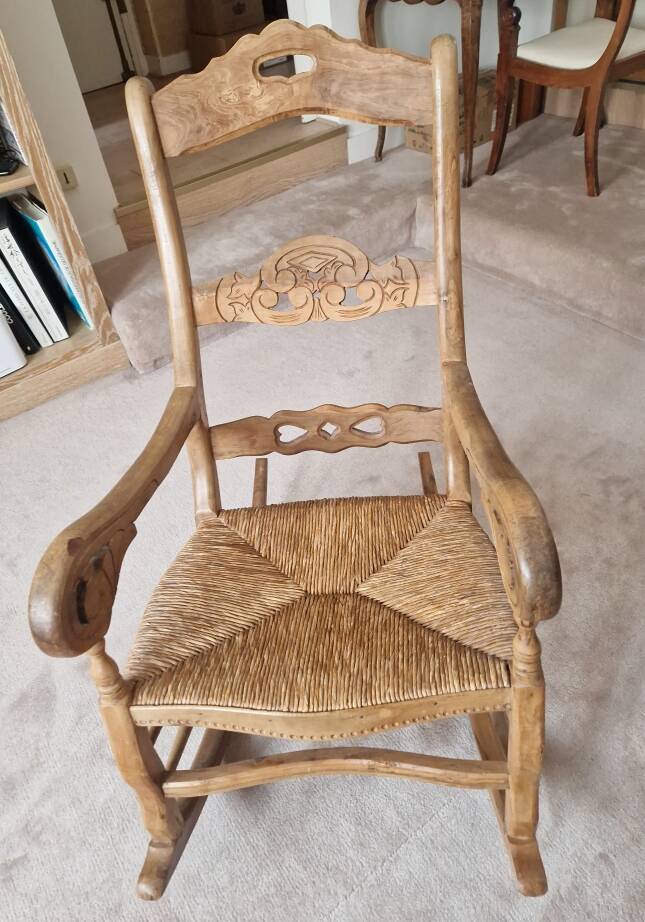 Oak rocking chair with a straw seat.