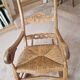 Oak rocking chair with a straw seat.