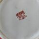 Vintage red Chinese teapot decorated with dragons and symbols.