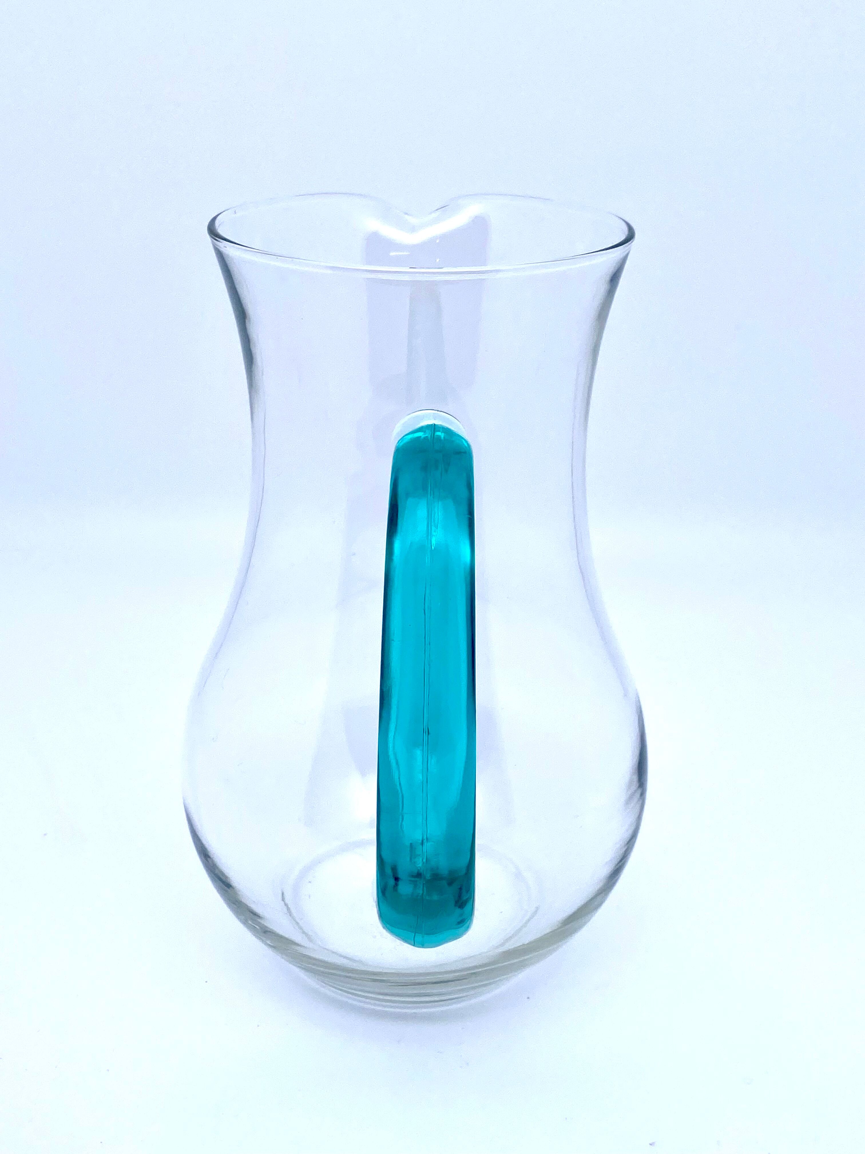 Transparent glass decanter and green handle